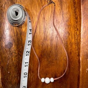 White beads on tan cord necklace
